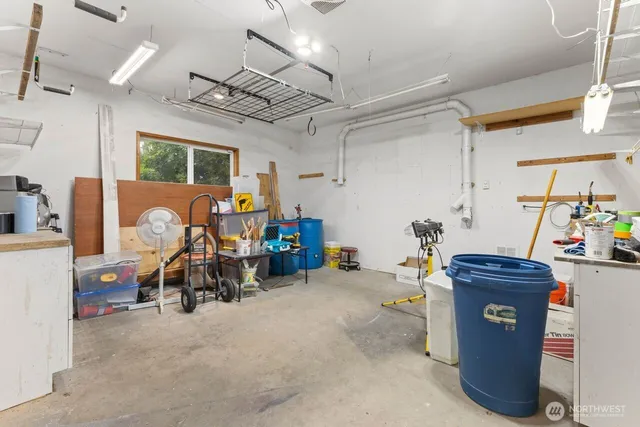 a view of a patio with table and chairs potted plants and large tree