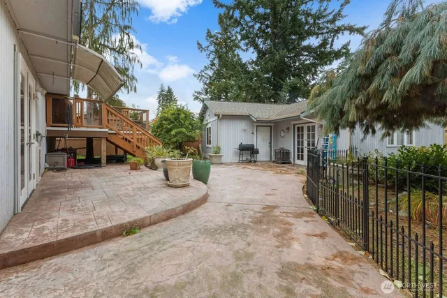 a view of a house with a patio and backyard