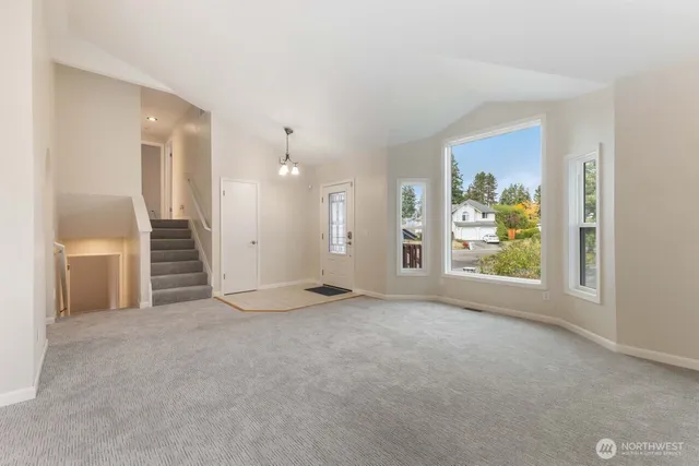 an empty room with windows and closet