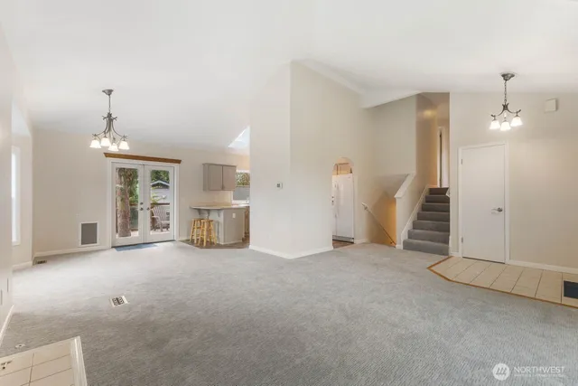 an empty room with fireplace and windows