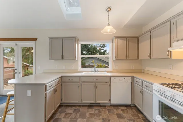 a kitchen that has a sink and a stove in it