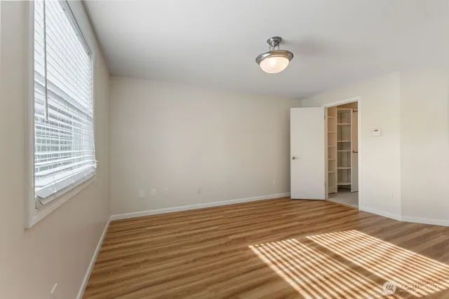 a view of a livingroom with wooden floor and window