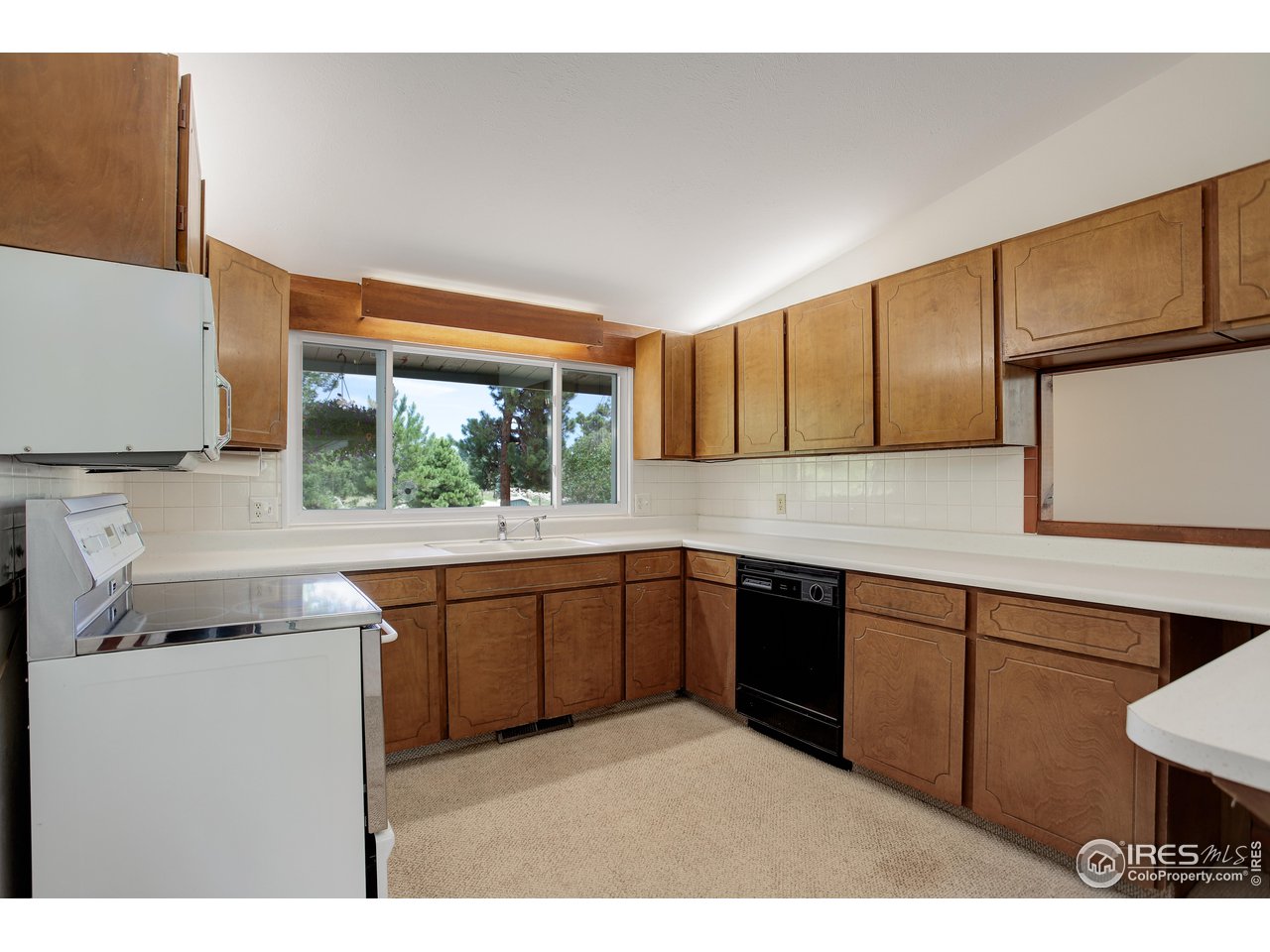 107 Deer Trail Road Boulder, CO 80302 - Photo 17 of 40 a kitchen with stainless steel appliances granite countertop sink stove and cabinets