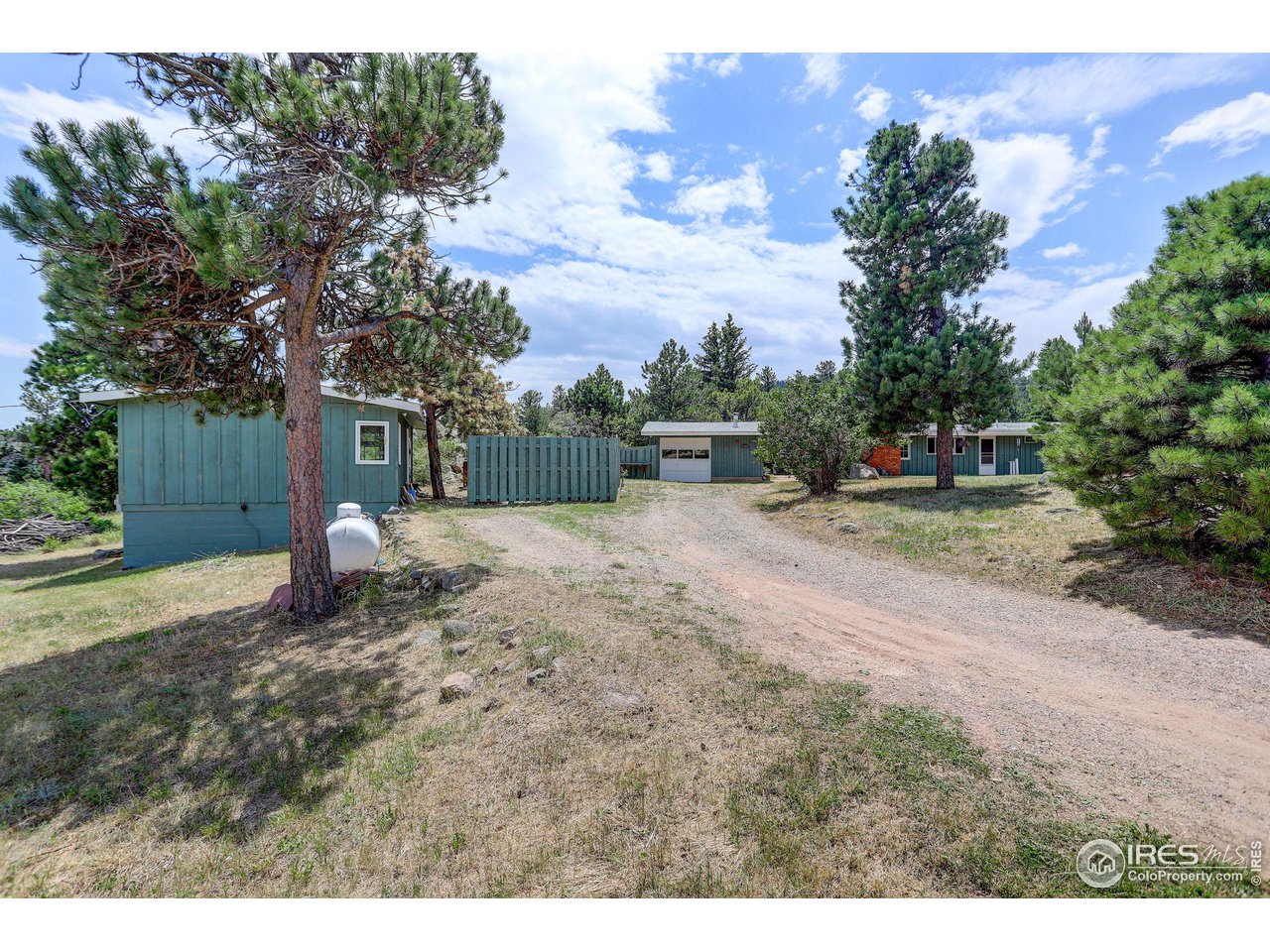 107 Deer Trail Road Boulder, CO 80302 - Photo 3 of 40 a backyard of a house with table and chairs