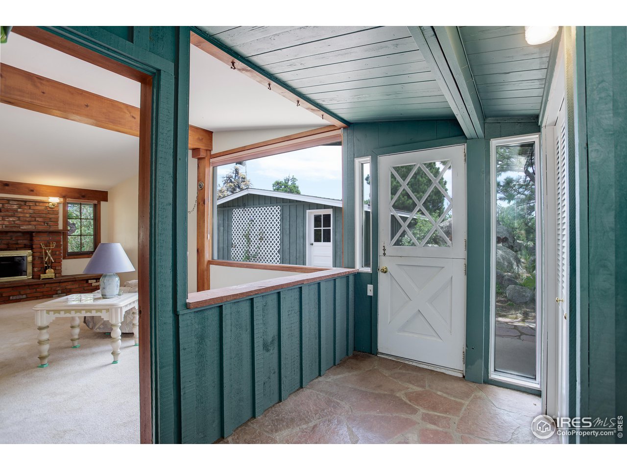 107 Deer Trail Road Boulder, CO 80302 - Photo 10 of 40 a view of a porch with a table and chairs