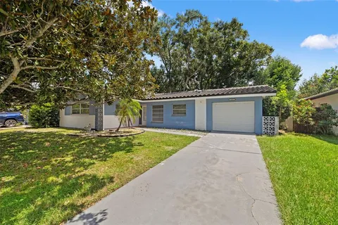 a front view of a house with a yard and a garage