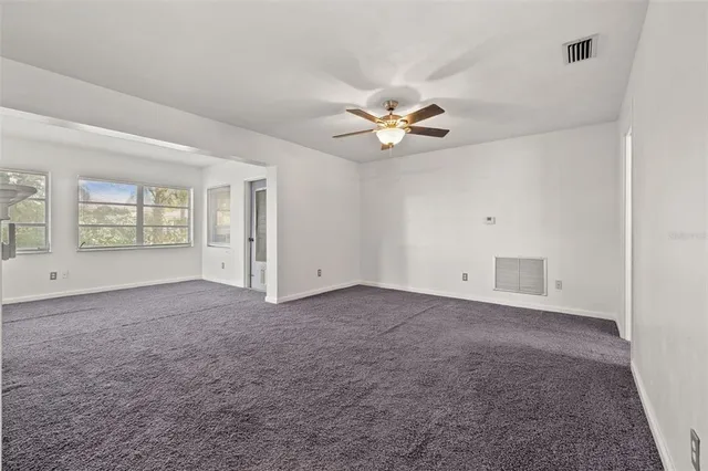 an empty room with a empty space and windows