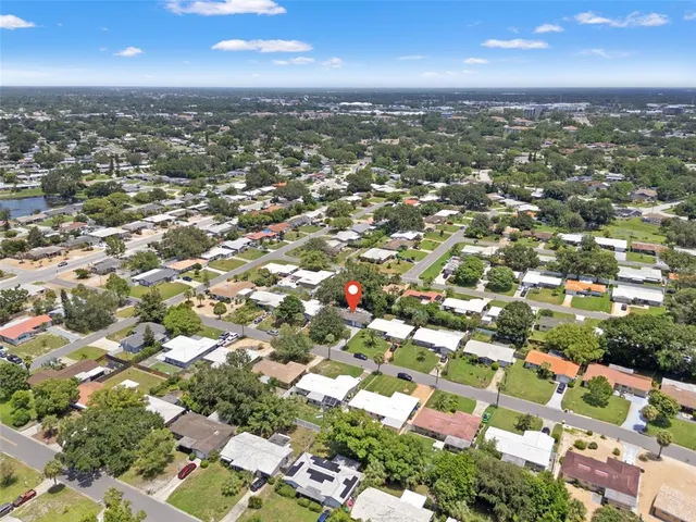 an aerial view of residential houses with city view