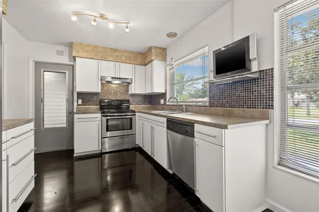 a kitchen with a stove microwave and a refrigerator