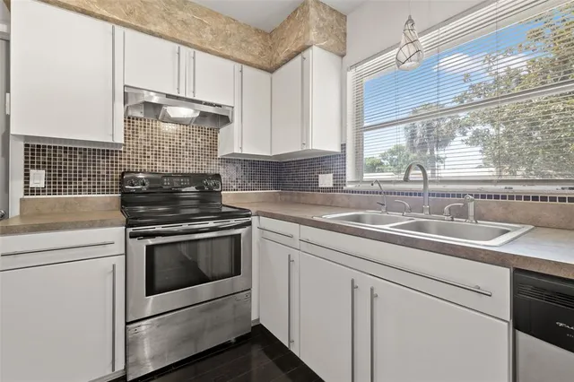 a kitchen with appliances cabinets and a sink
