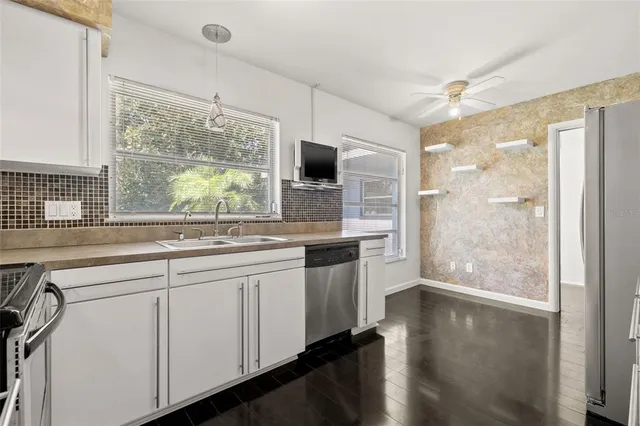 a kitchen with a counter top space and a large window