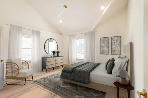 a bedroom with a bed and wooden floor