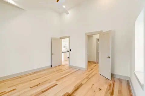 a view of a room with wooden floor and bathroom