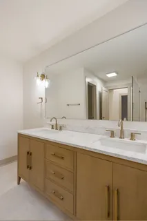 a bathroom with a granite countertop sink mirror and double