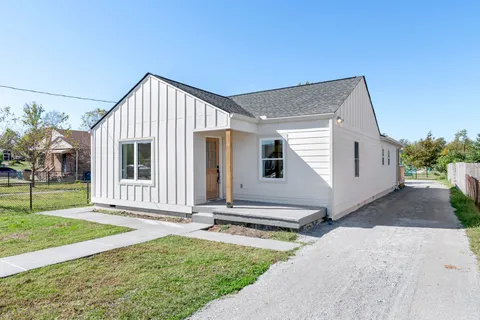 a backyard of a house with table and chairs