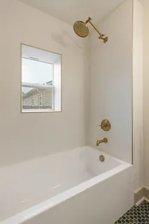 a bathroom with a bathtub and a shower
