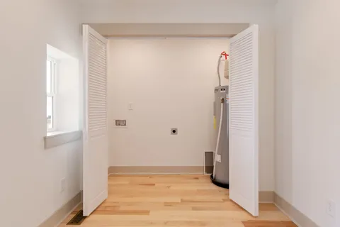a view of a hallway with wooden floor and entryway