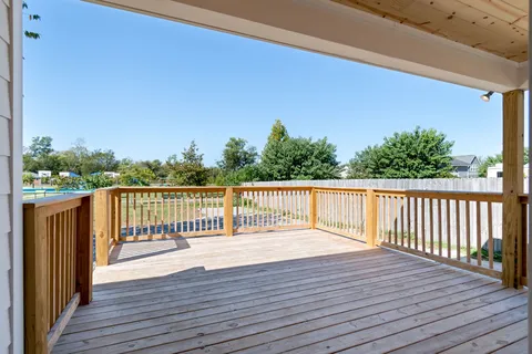 a balcony with wooden floor and fence