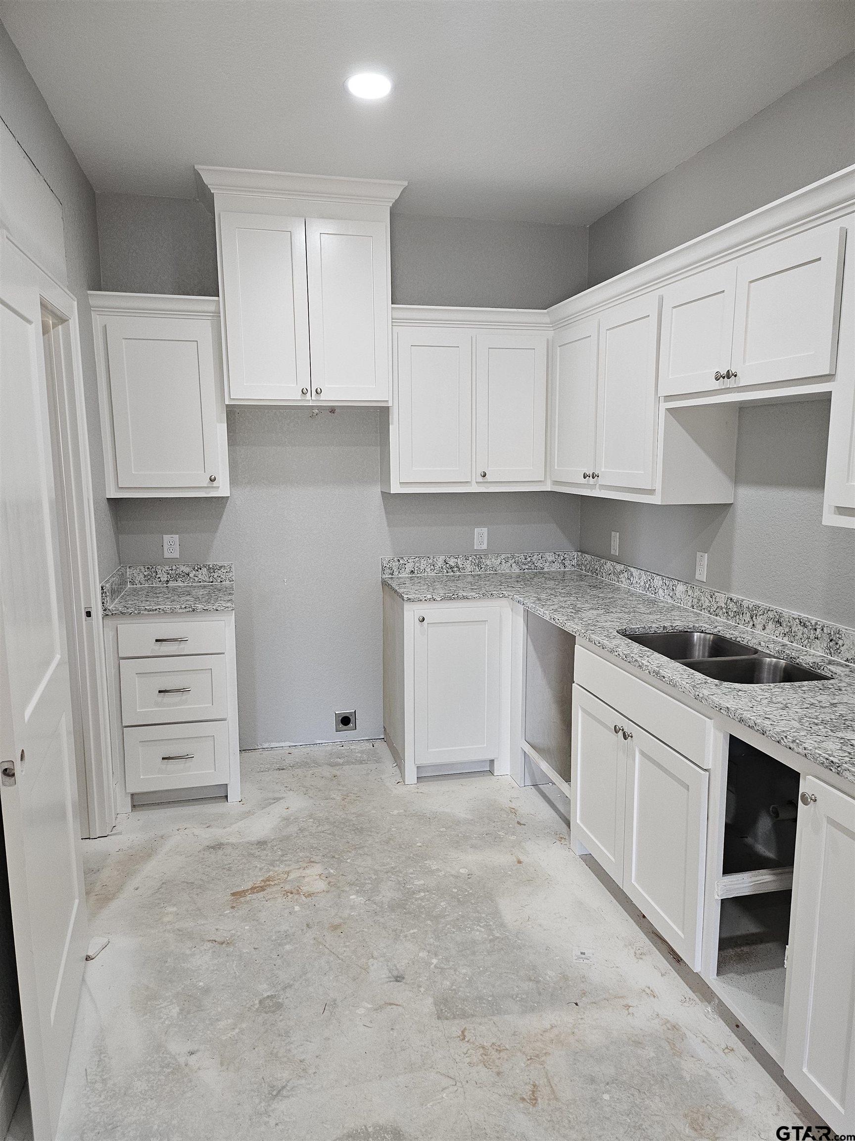 100 Cook Street, Unit 6 Arp, TX 75750 - Photo 2 of 8 a kitchen with granite countertop a stove top oven a sink and dishwasher