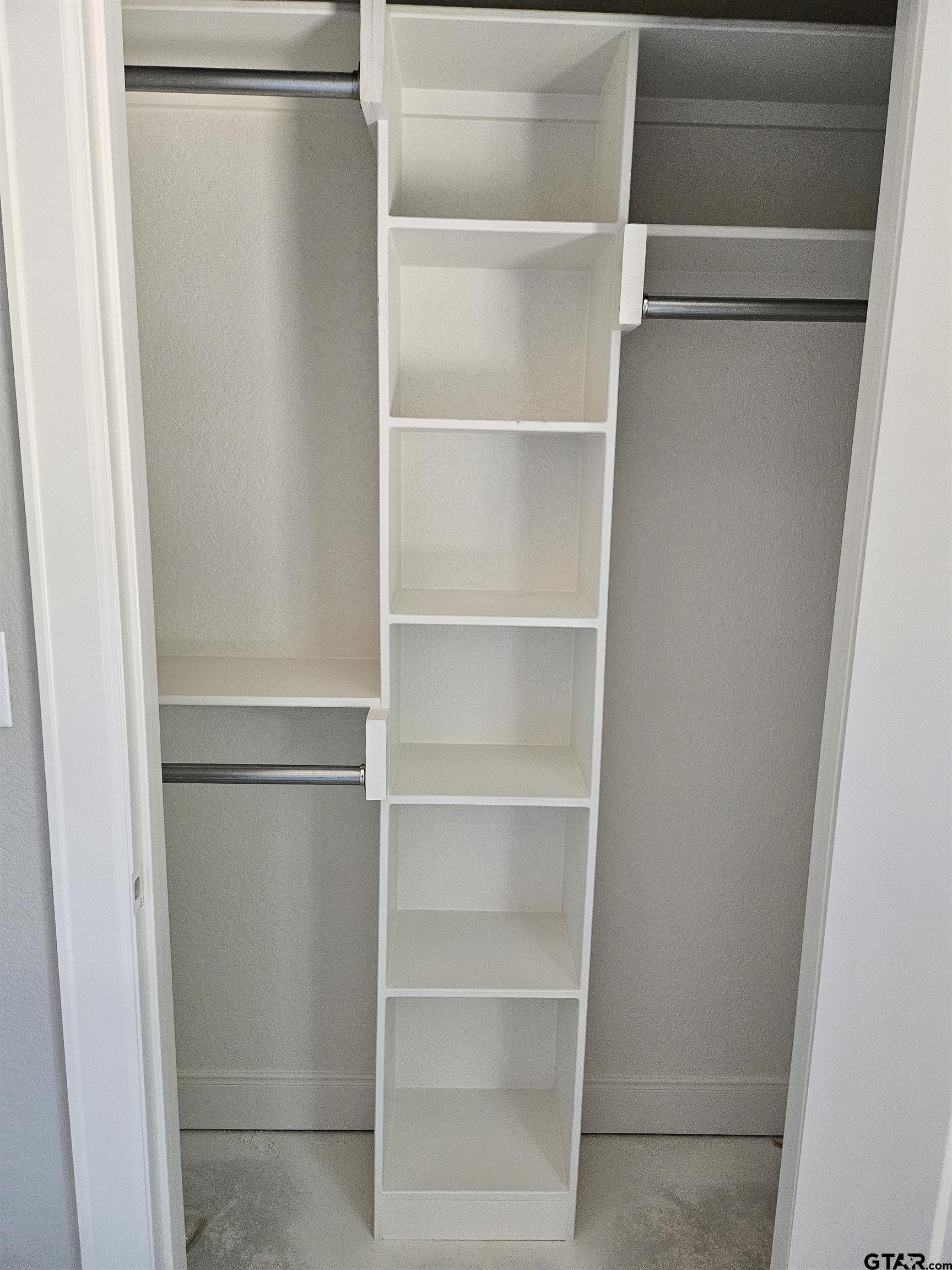 100 Cook Street, Unit 6 Arp, TX 75750 - Photo 6 of 8 a view of walk in closet with empty racks