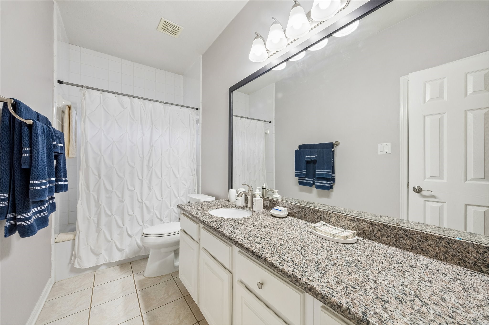 12423 Rutgers Park Court Houston, TX 77058 - Photo 27 of 29 a bathroom with a granite countertop sink and a mirror