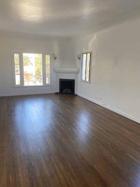 744 Walnut Avenue Long Beach, CA 90813 - Photo 32 of 41 an empty room with wooden floor fireplace and windows