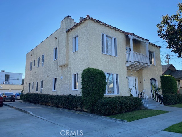 744 Walnut Avenue Long Beach, CA 90813 - Photo 4 of 41 a view of a white house with many windows and potted plants