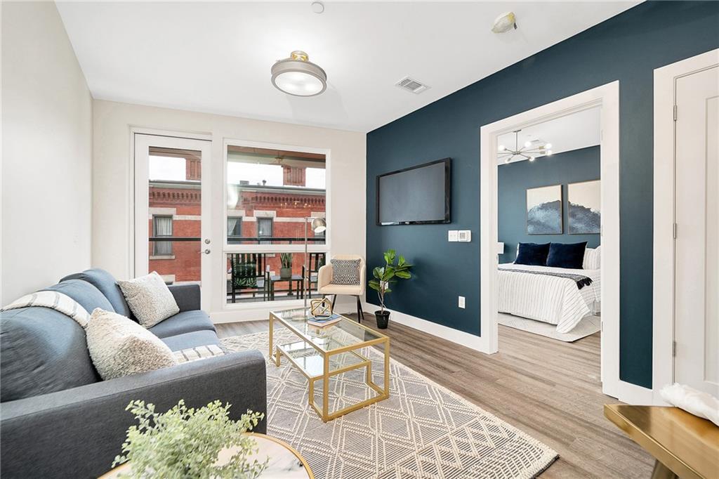 3725 Butler Street, Unit 406 Pittsburgh, PA 15201 - Photo 2 of 21 a living room with furniture and a large window