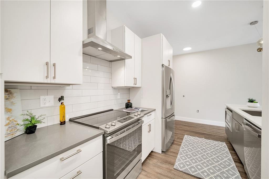 3725 Butler Street, Unit 406 Pittsburgh, PA 15201 - Photo 3 of 21 a kitchen with stainless steel appliances granite countertop a sink a stove and a refrigerator