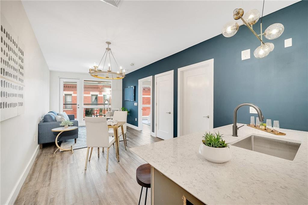 3725 Butler Street, Unit 406 Pittsburgh, PA 15201 - Photo 5 of 21 a dining room with furniture a chandelier and wooden floor