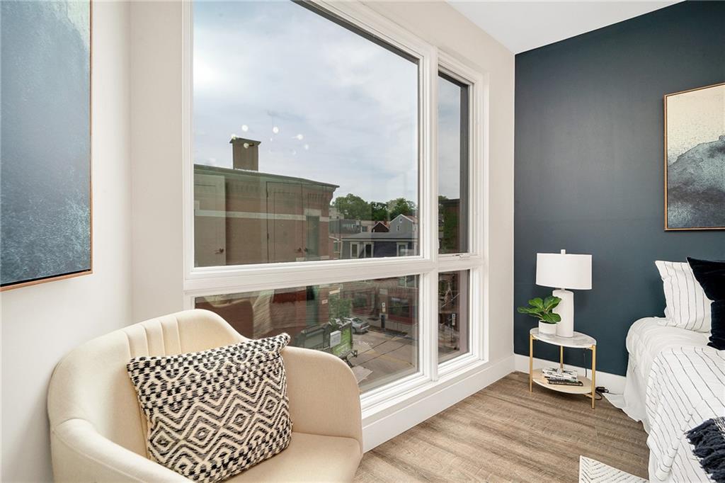 3725 Butler Street, Unit 406 Pittsburgh, PA 15201 - Photo 10 of 21 a living room with a large window and a table