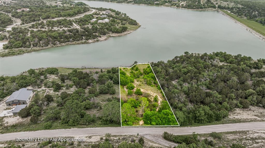1165 Anchor Way Bluff Dale, TX 76433 - Photo 1 of 40 an aerial view of a house with a yard and lake view