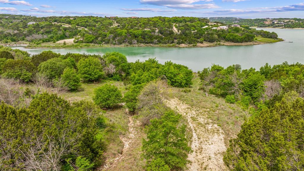 1165 Anchor Way Bluff Dale, TX 76433 - Photo 17 of 40 a view of a lake with houses in the back