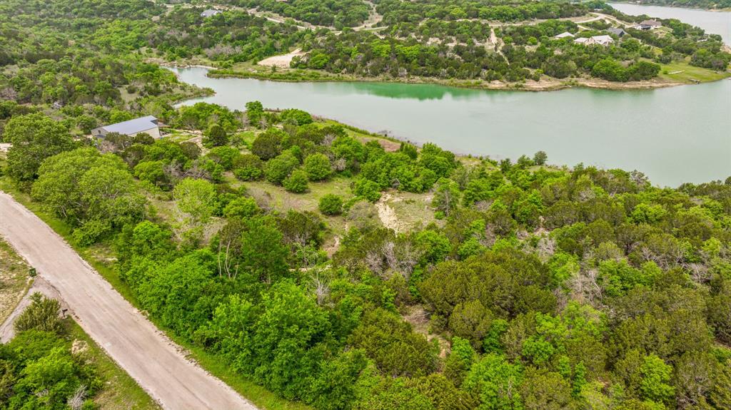 1165 Anchor Way Bluff Dale, TX 76433 - Photo 19 of 40 a view of a lake with a mountain in the background