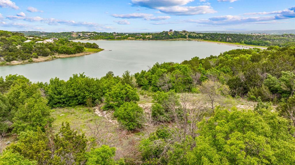 1165 Anchor Way Bluff Dale, TX 76433 - Photo 25 of 40 a view of a lake with houses in the back