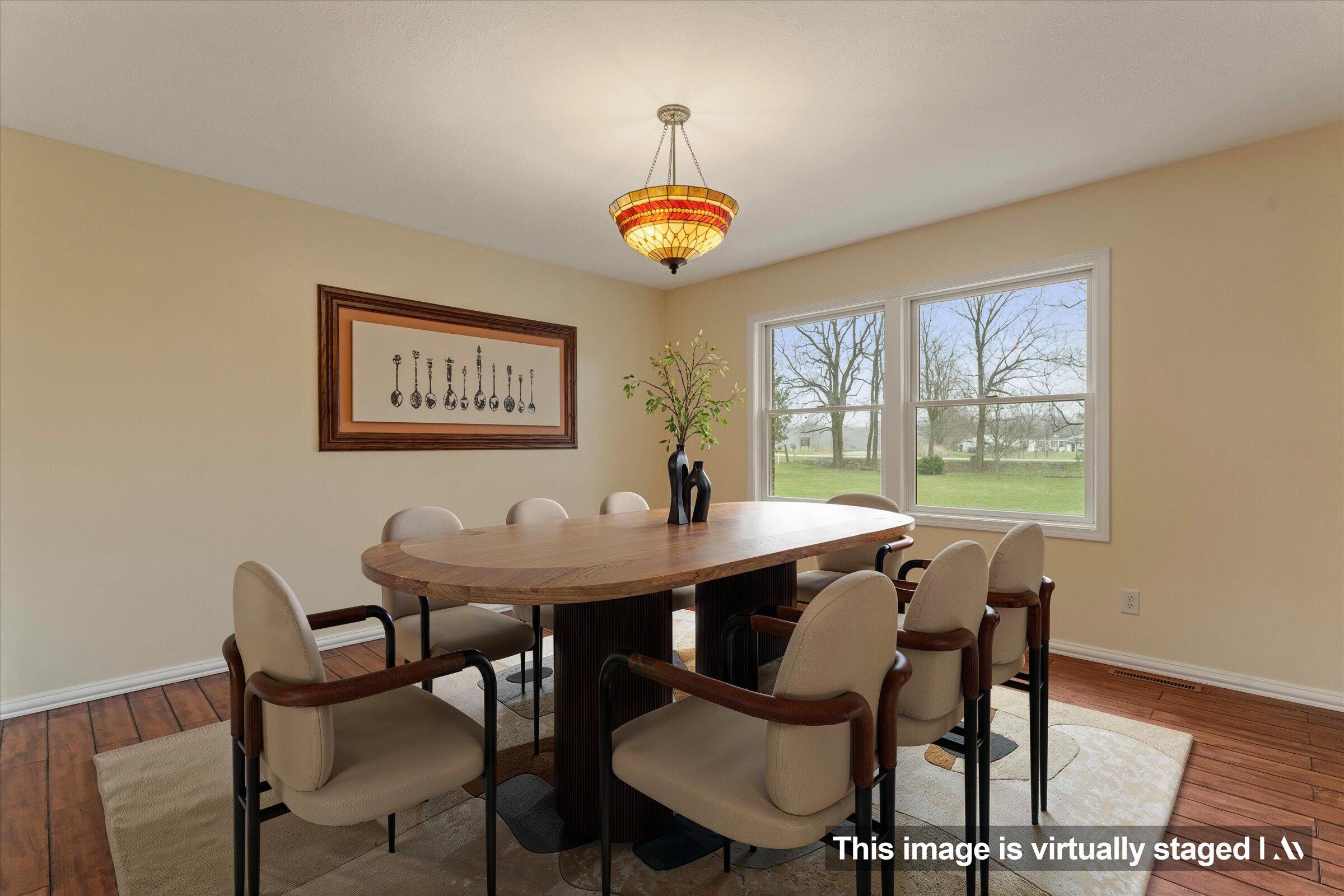 7692 North Emery Road Rolling Prairie, IN 46371 - Photo 6 of 69 a view of a dining room with furniture and a window