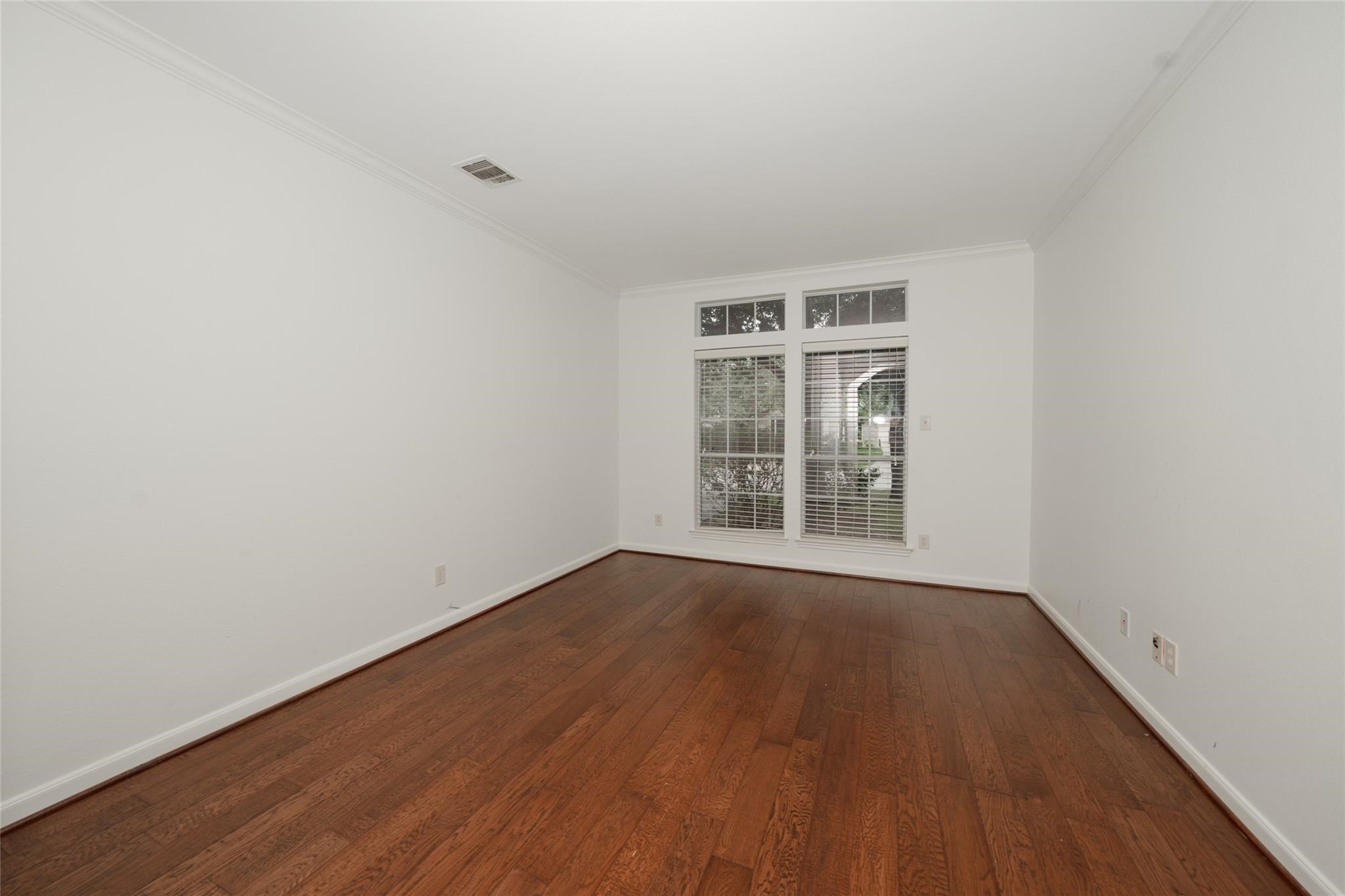 14830 Barton Grove Lane Humble, TX 77396 - Photo 15 of 36 a view of an empty room with wooden floor and a window