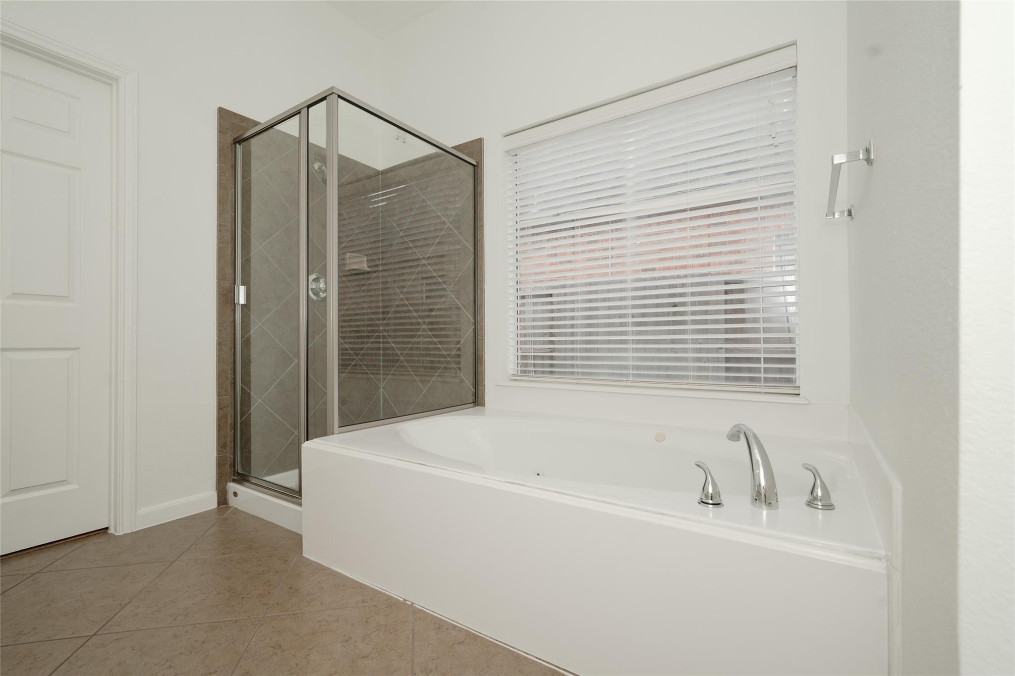 14830 Barton Grove Lane Humble, TX 77396 - Photo 18 of 36 a bathroom with a bathtub and a shower