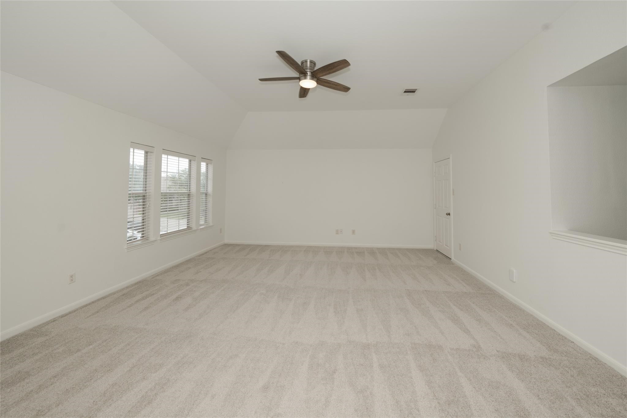 14830 Barton Grove Lane Humble, TX 77396 - Photo 20 of 36 an empty room with a ceiling fan and window