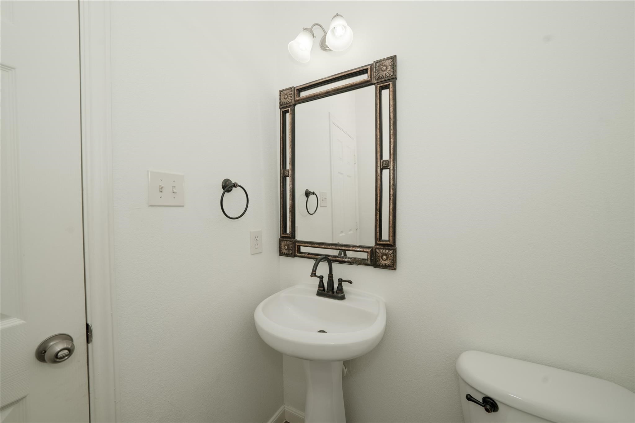 14830 Barton Grove Lane Humble, TX 77396 - Photo 28 of 36 a bathroom with a sink a toilet and mirror