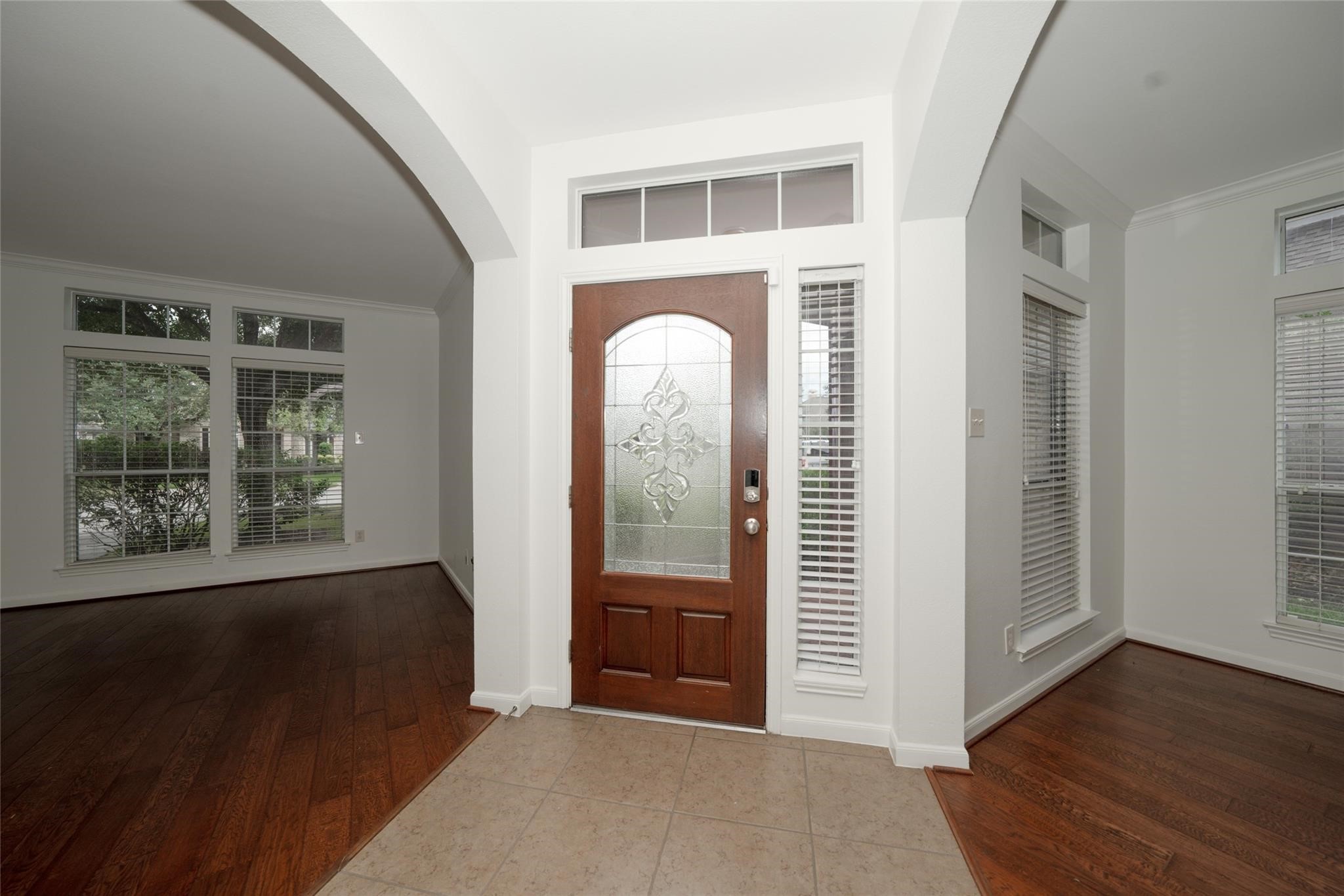 14830 Barton Grove Lane Humble, TX 77396 - Photo 4 of 36 an empty room with wooden floor mirror and windows