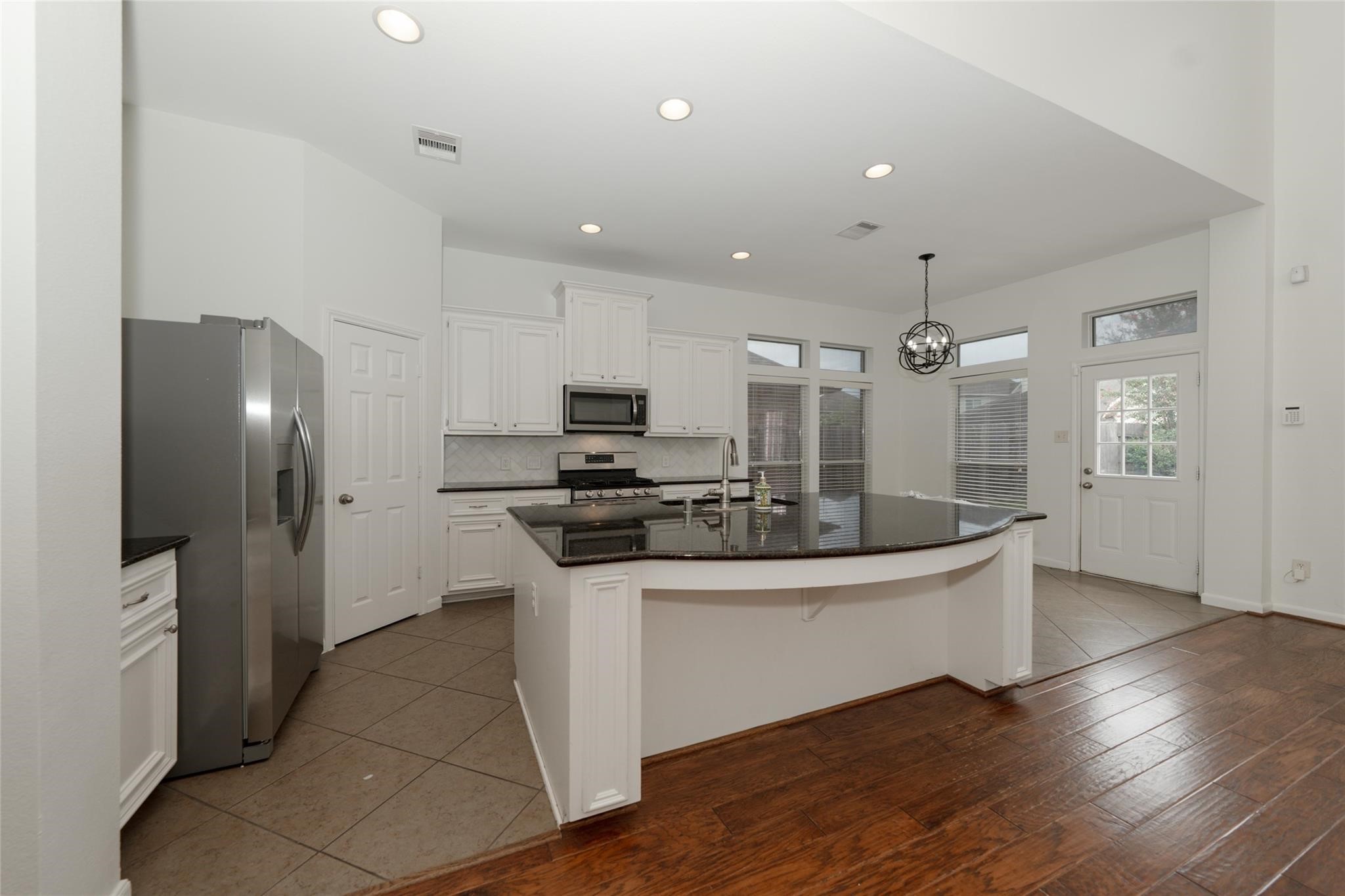 14830 Barton Grove Lane Humble, TX 77396 - Photo 9 of 36 a kitchen with stainless steel appliances kitchen island a sink and refrigerator