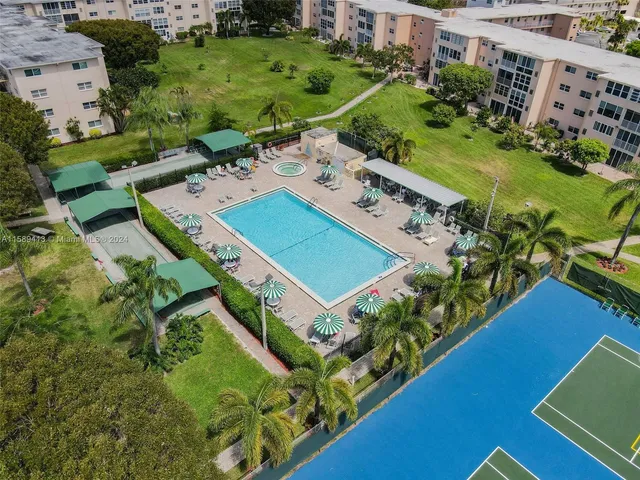 an aerial view of a residential houses with outdoor space and street view