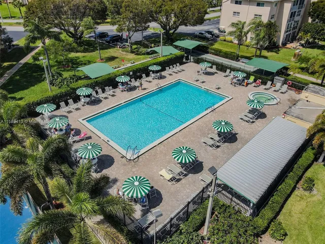 an aerial view of a tennis ground and a swimming pool