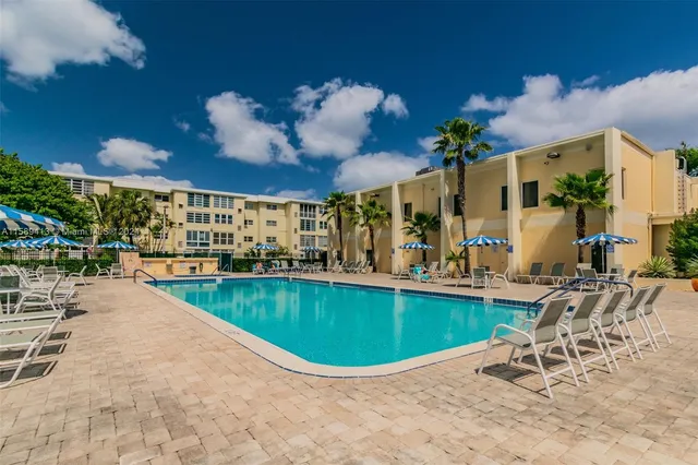a view of a swimming pool with outdoor seating