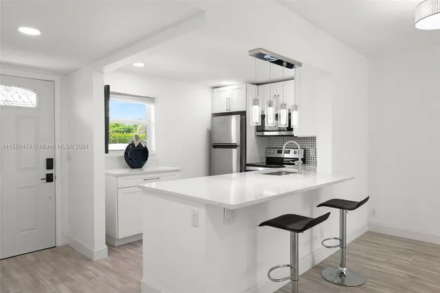 a kitchen with stainless steel appliances a refrigerator and a stove