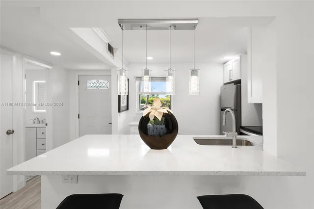 a kitchen with a refrigerator and a sink