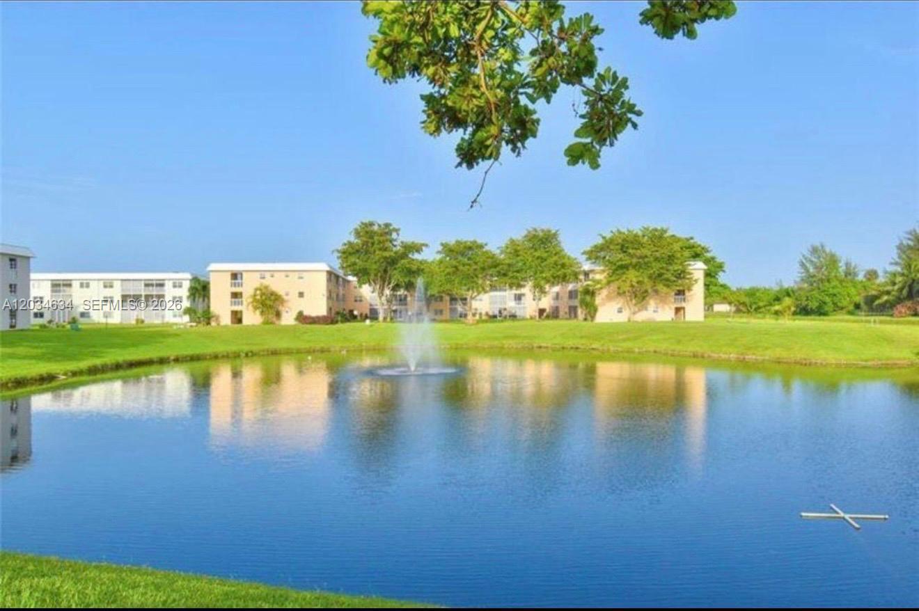 9880 Marina Boulevard, Unit 1516 Boca Raton, FL 33428 - Photo 28 of 32 a view of a lake with a house in the background