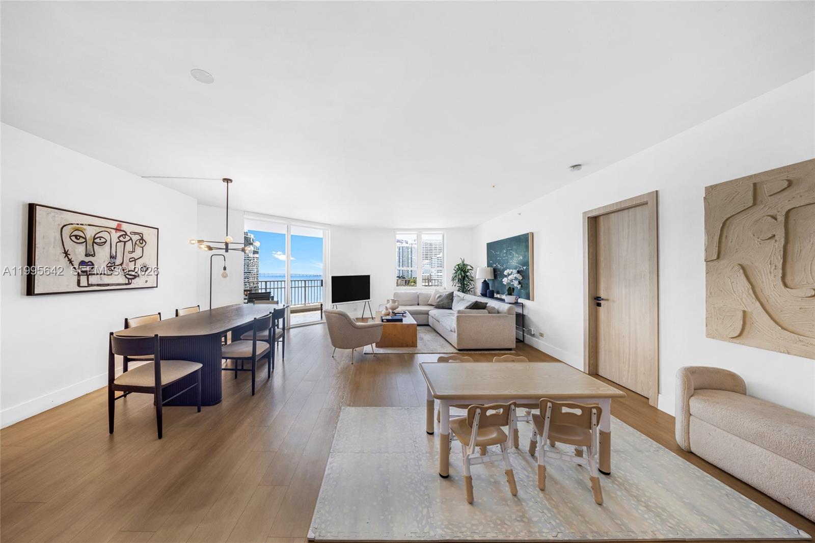 701 Brickell Key Boulevard, Unit 1112 Miami, FL 33131 - Photo 1 of 31 a living room with furniture a rug and a painting on the wall