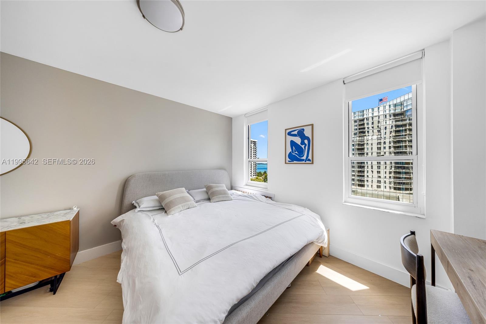 701 Brickell Key Boulevard, Unit 1112 Miami, FL 33131 - Photo 12 of 31 a bedroom with a bed and a dresser next to a window